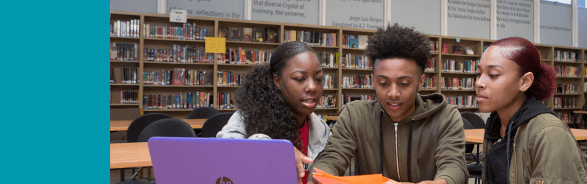 Three students collaborating in school library