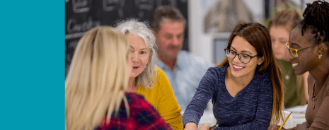 Multiple teachers having a discussion at a table