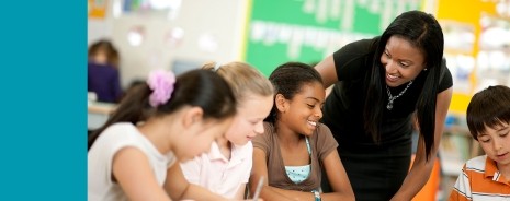 African American female teacher interacting with students