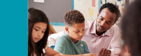 African American male teacher interacting with male student