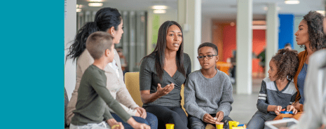 Parent and child having a serious discussion with other parents and children